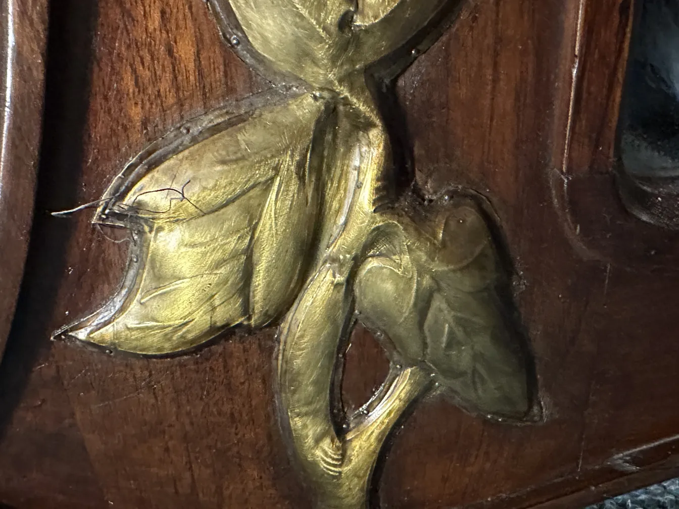 antique mirror adorned with golden leaf carvings
