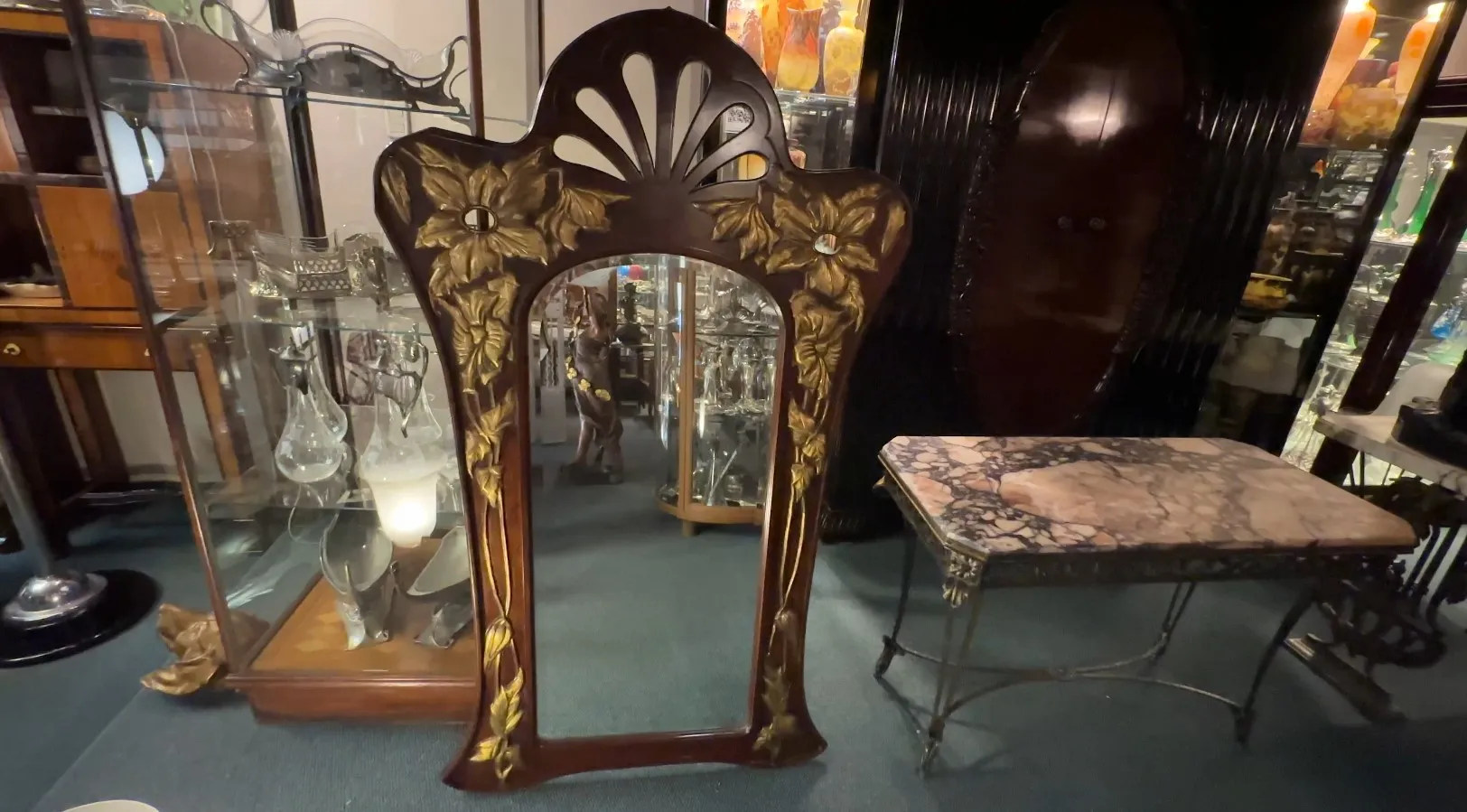 Antique mirror with a floral patterned frame.
