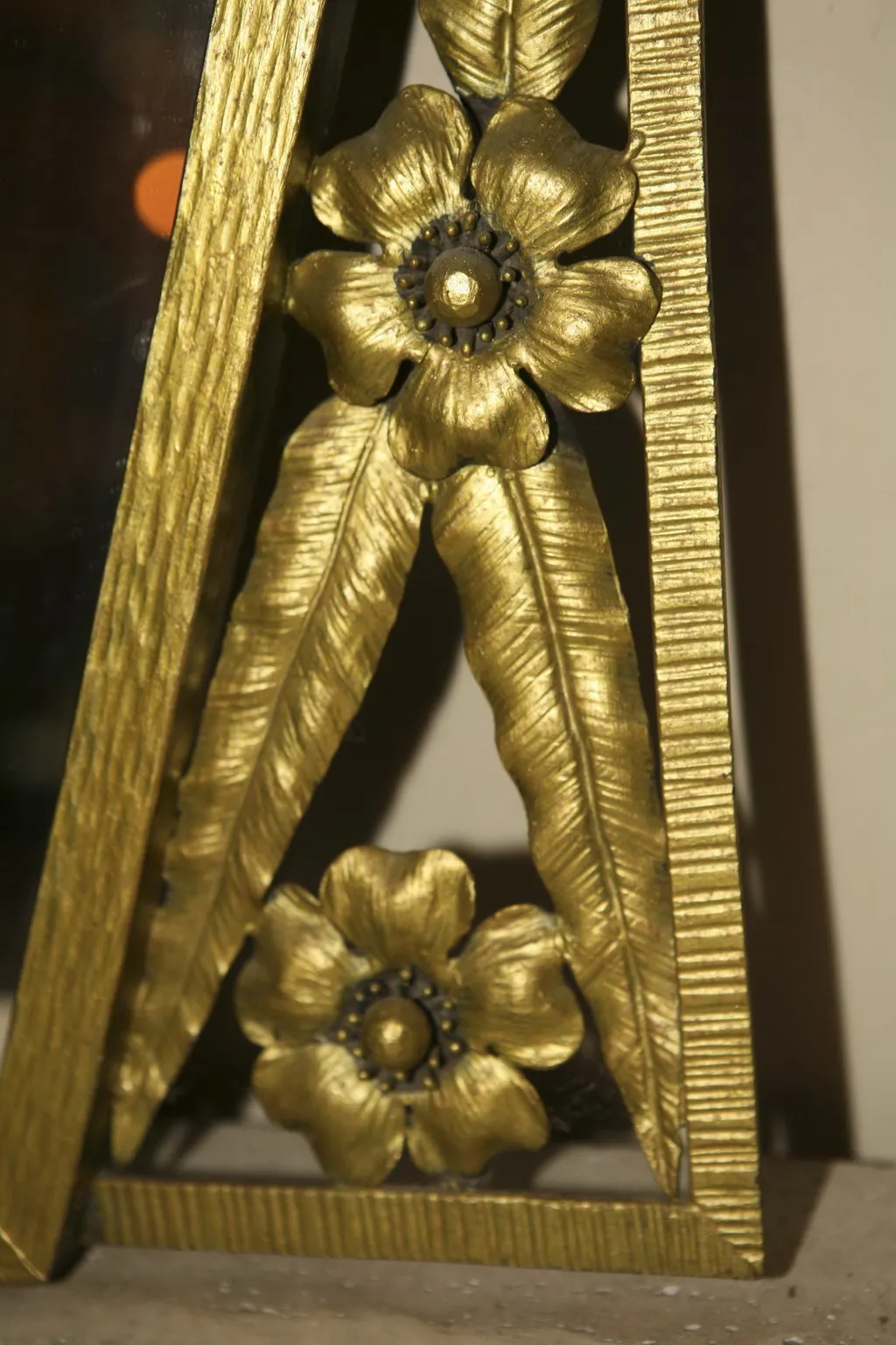 antique mirror with gold frame, featuring floral designs