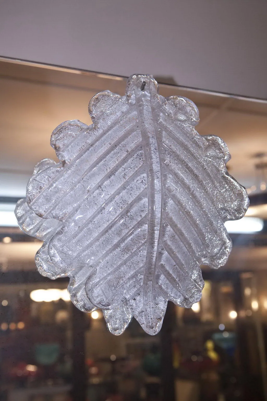 decorative antique mirror shaped like a leaf, soft background