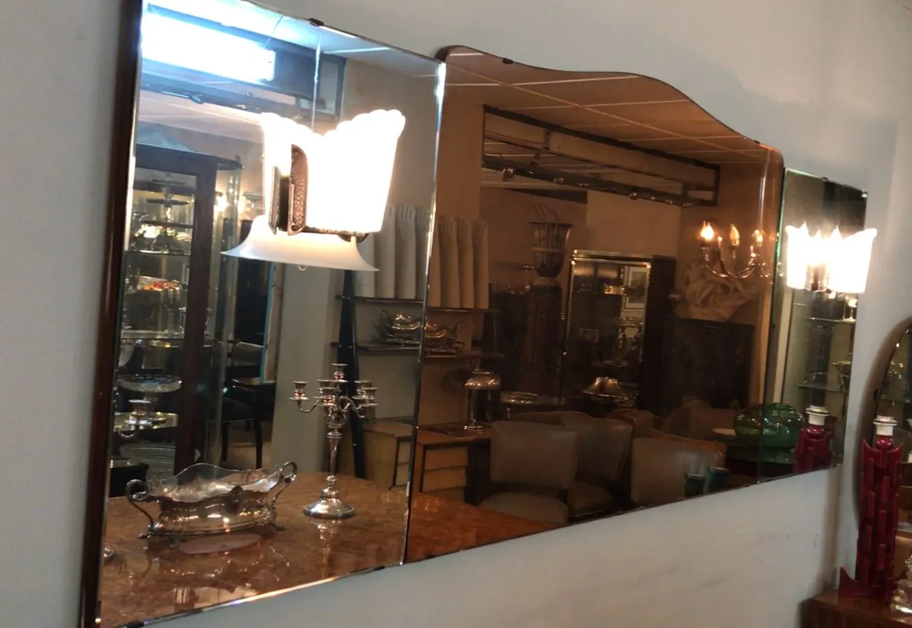 antique mirror with reflections and illuminated lamp