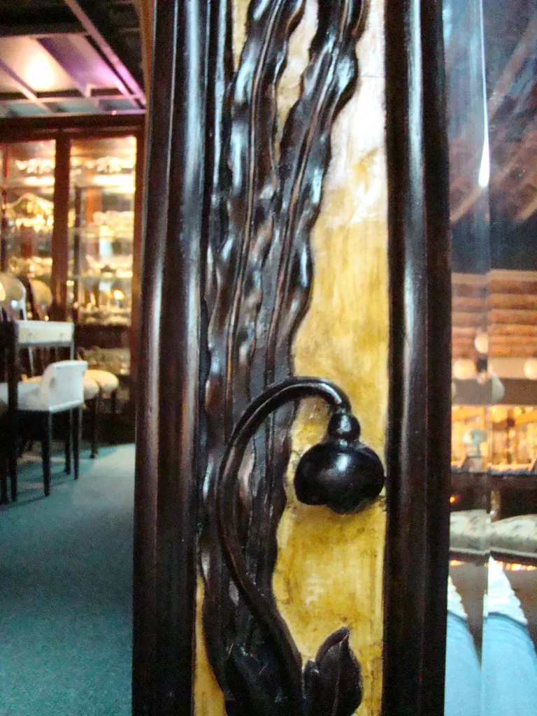 antique mirror with art nouveau details in a cozy setting