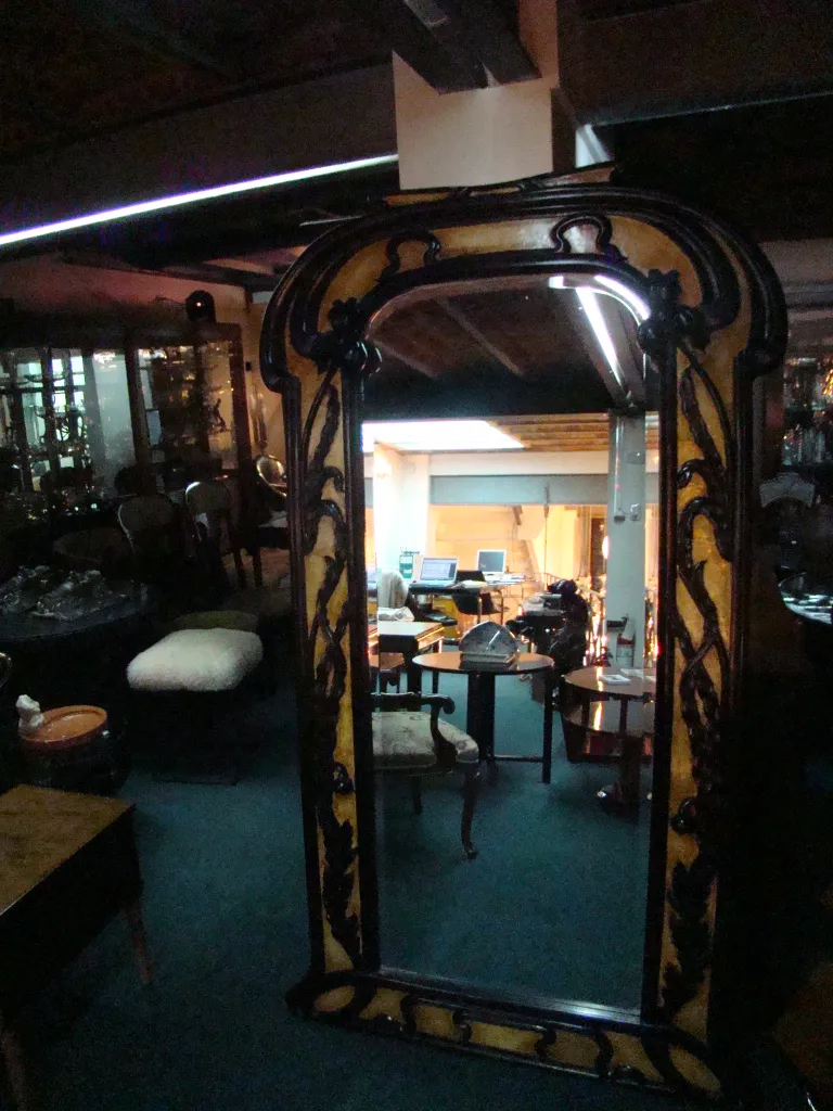 Antique mirror with ornate frame in classic setting