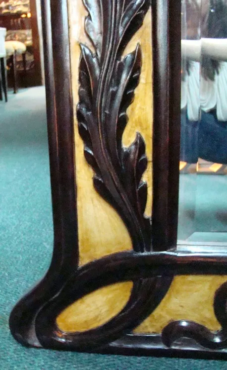 Antique mirror with decorative frame in a classic setting.