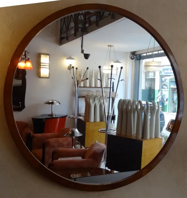 antique oval mirror in a vintage setting with furniture