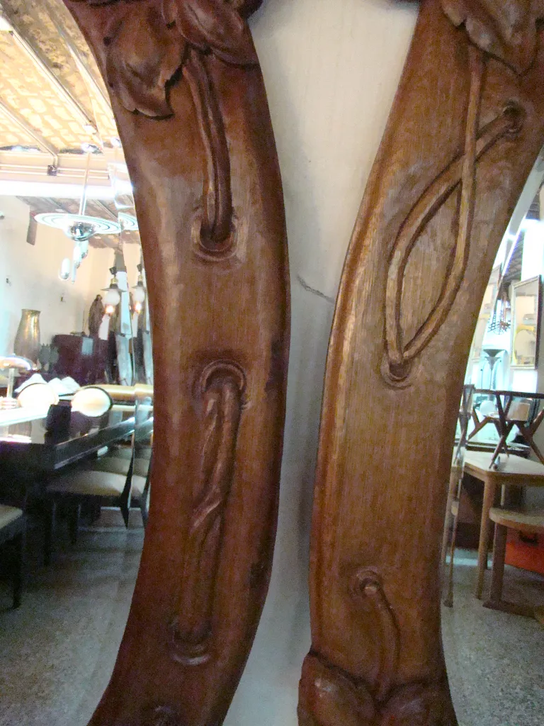 antique mirror with intricately carved frame and fine details in a classic setting