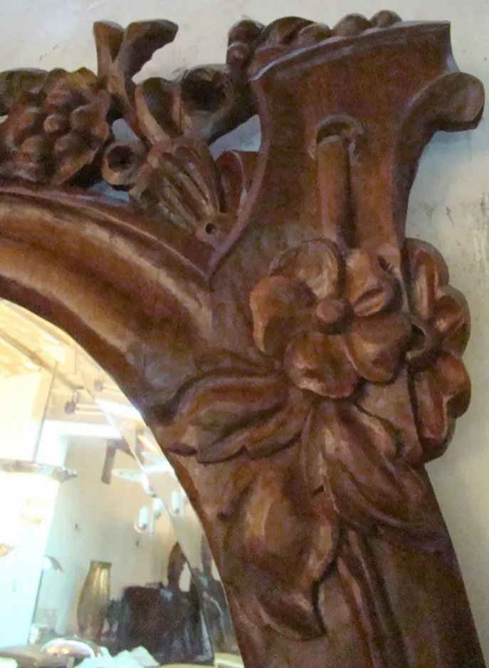 antique mirror with carvings in the shape of flowers