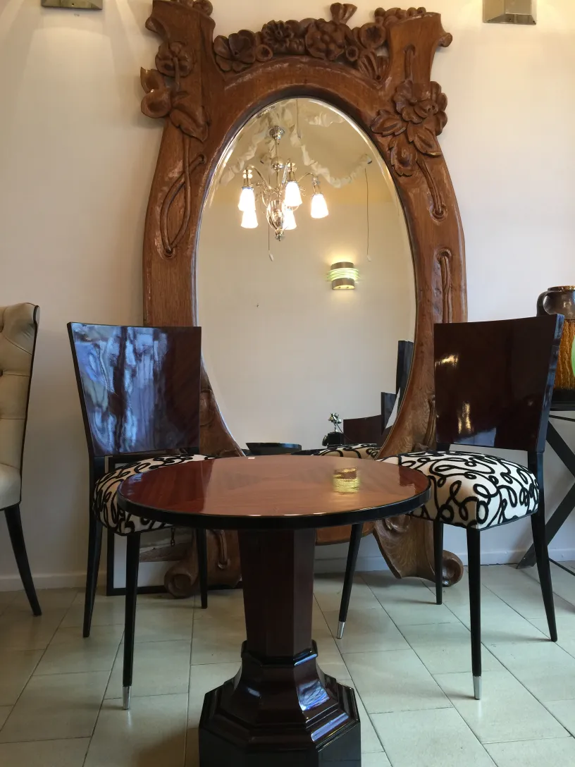 antique mirror with decorative frame and chairs