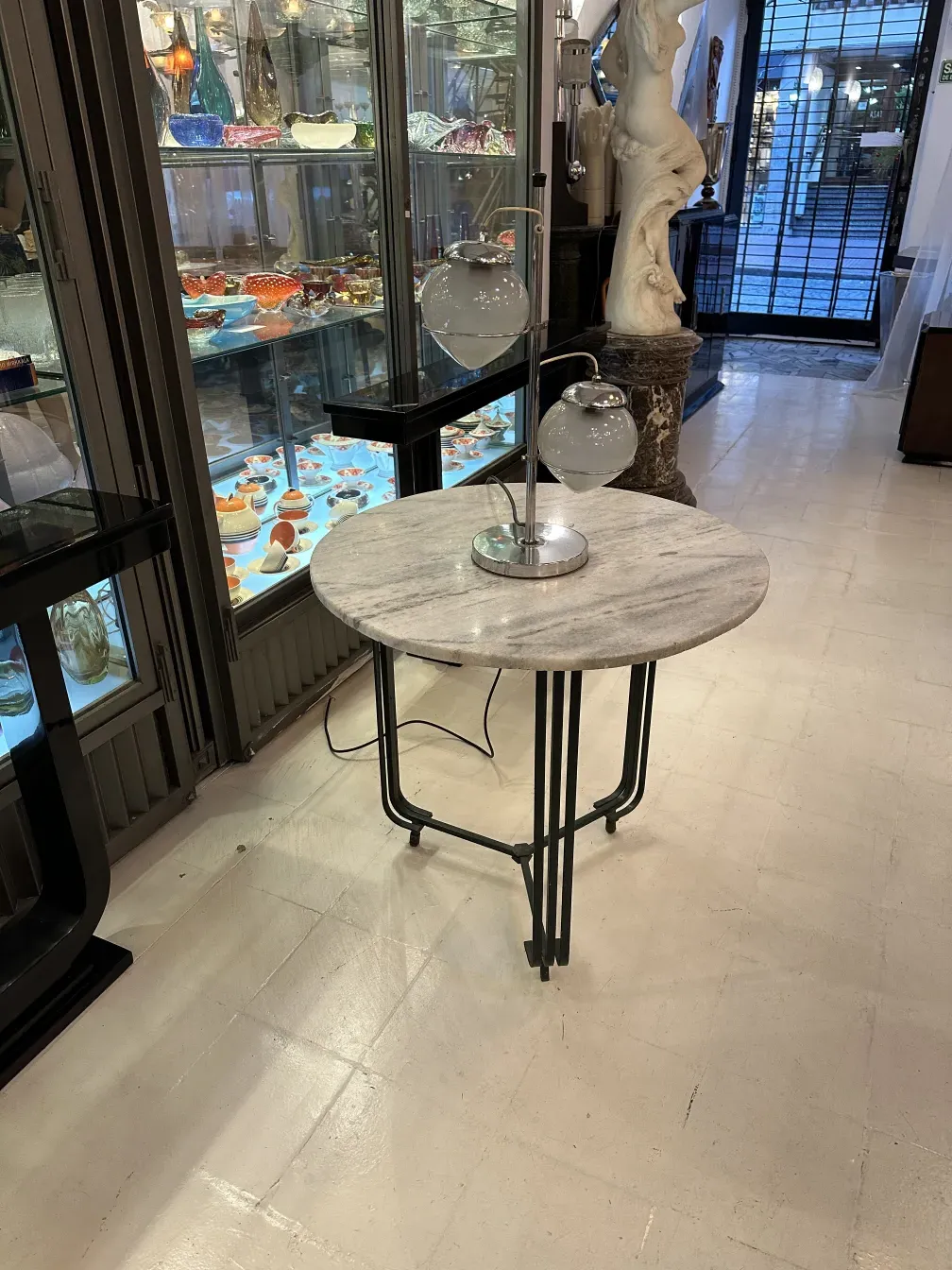 luminaria de mesa antiga em forma redonda com duas lâmpadas em uma loja de antiguidades