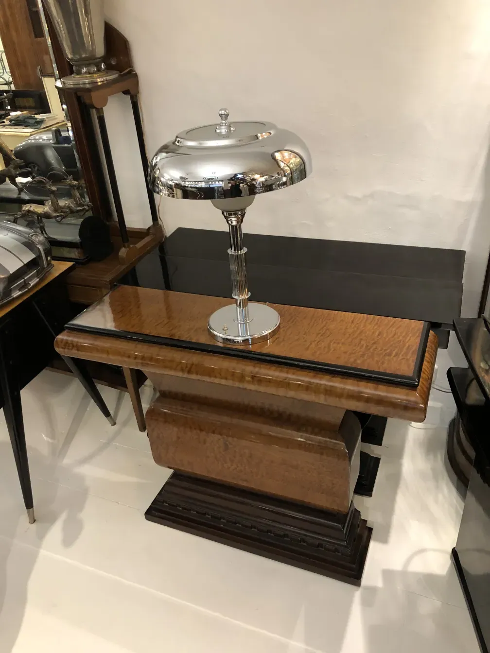 antiga luminária de mesa com base brilhante e design elegante em um ambiente de antiguidades