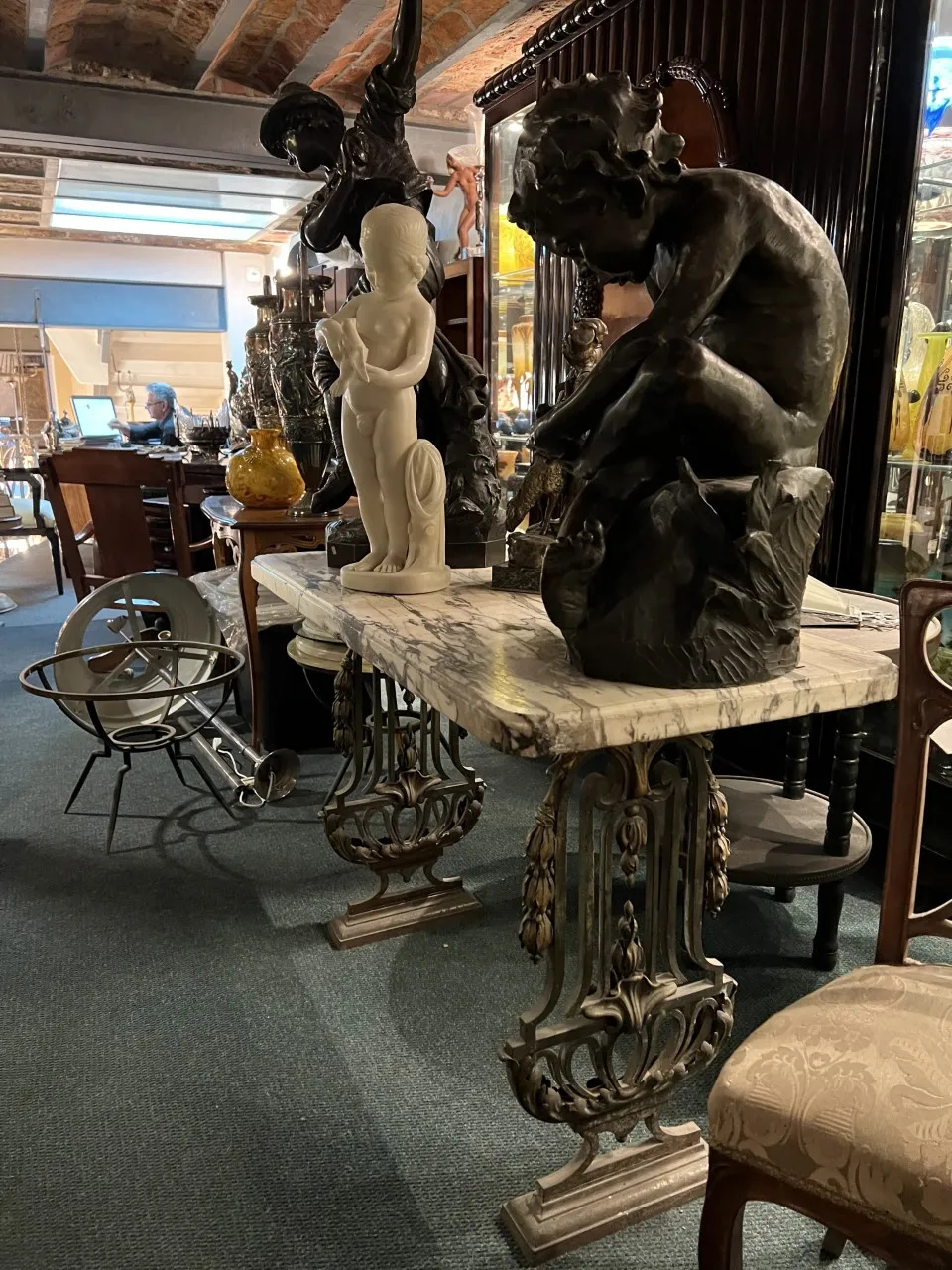 Antique decorative console with sculptures in an elegant setting