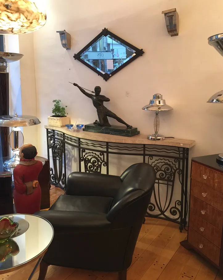 antique decorative console with sculpture and lamp