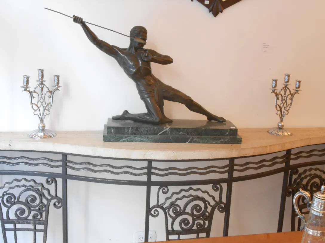 antique console with central decorative figure and candlesticks