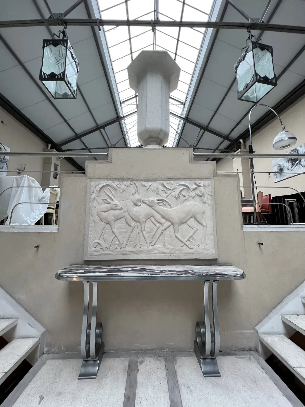 Antique console Montagnac Pierre with decorative relief on wall.