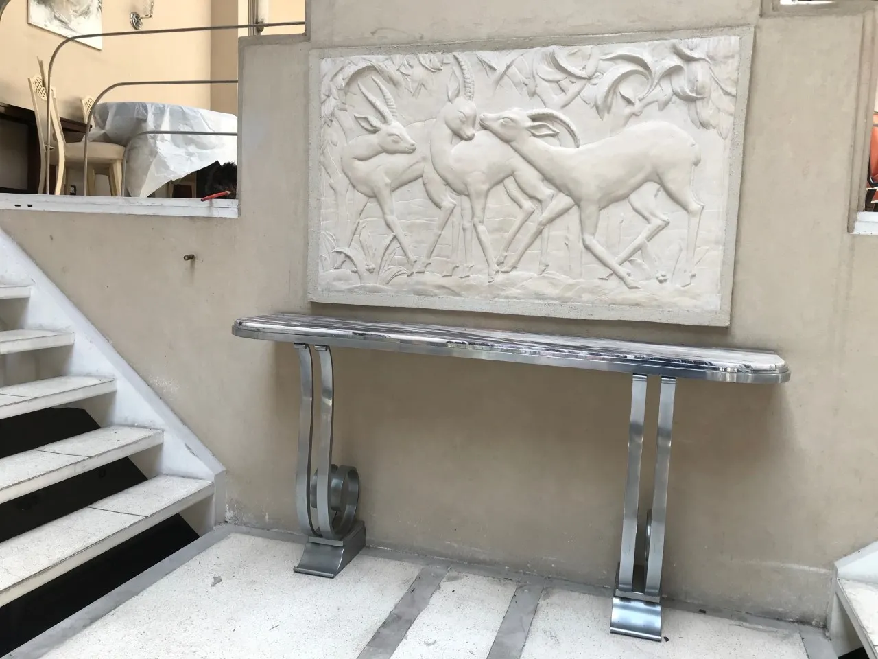 antique console with relief details, decorated with deer