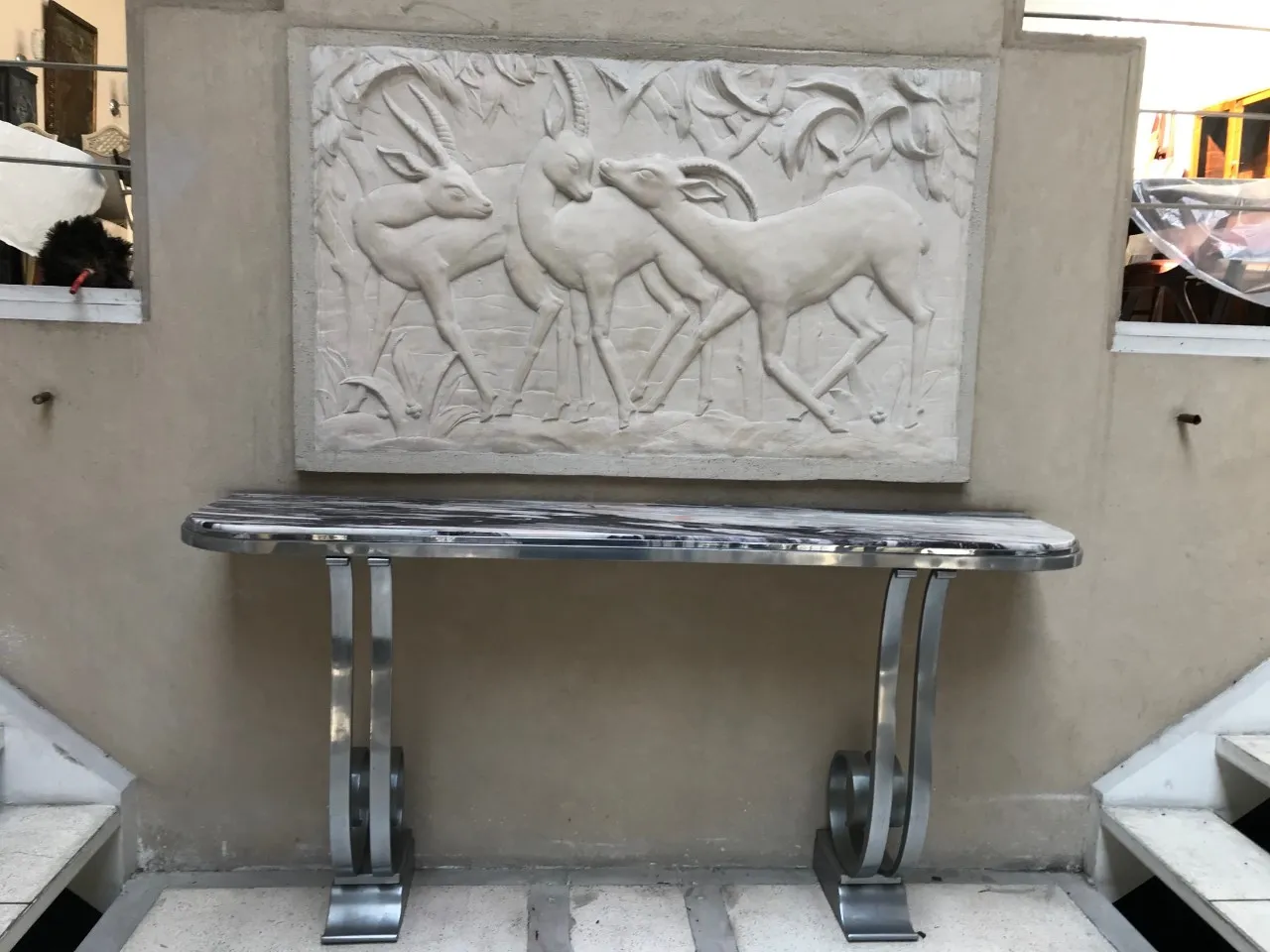 antique console with decorative relief and neutral background