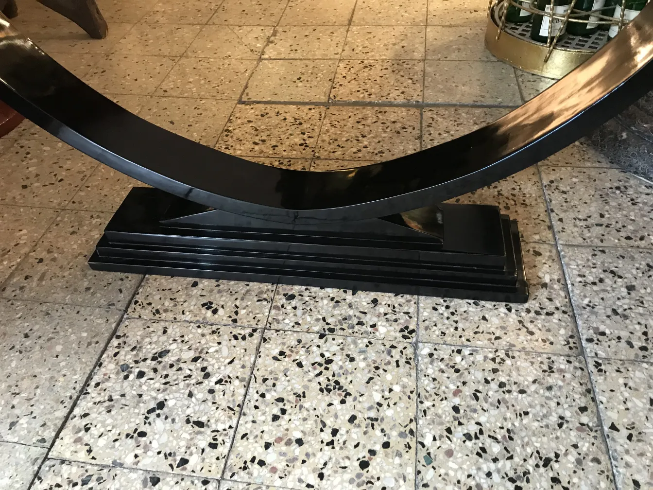 antique decorative console with black base in an empty setting