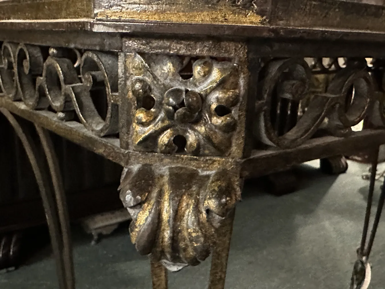 Intricate details on the base of an antique decorative console, vintage atmosphere.