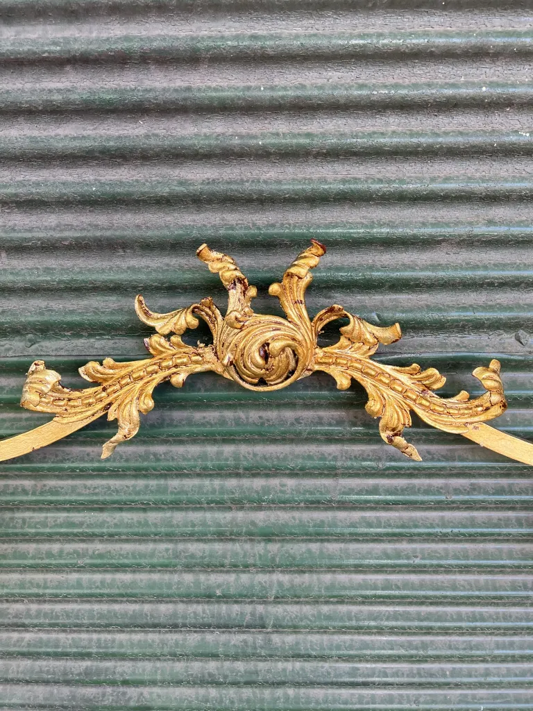Golden details on antique console with ornamental design