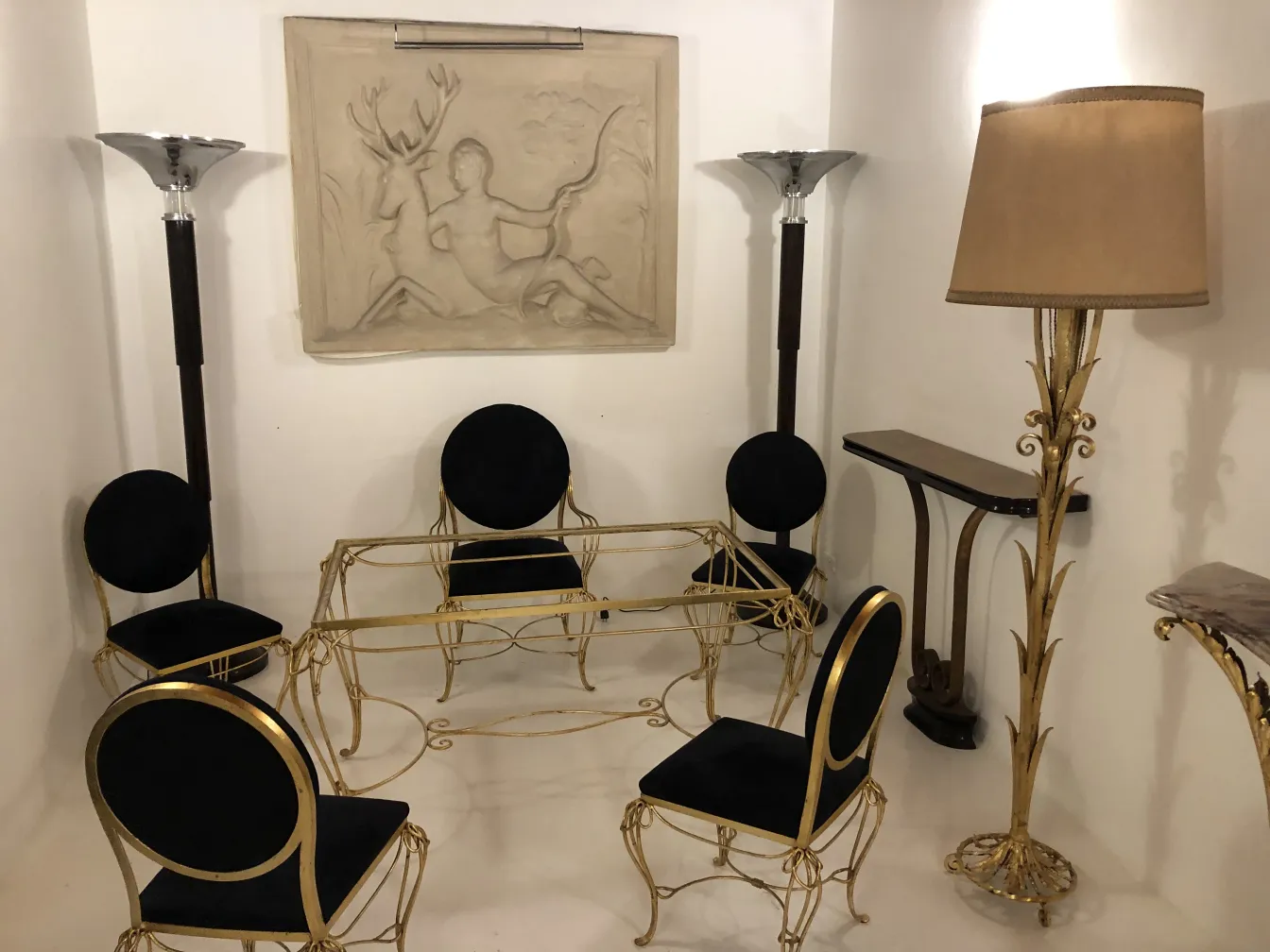 Antique decorative console with elegant table and chairs.