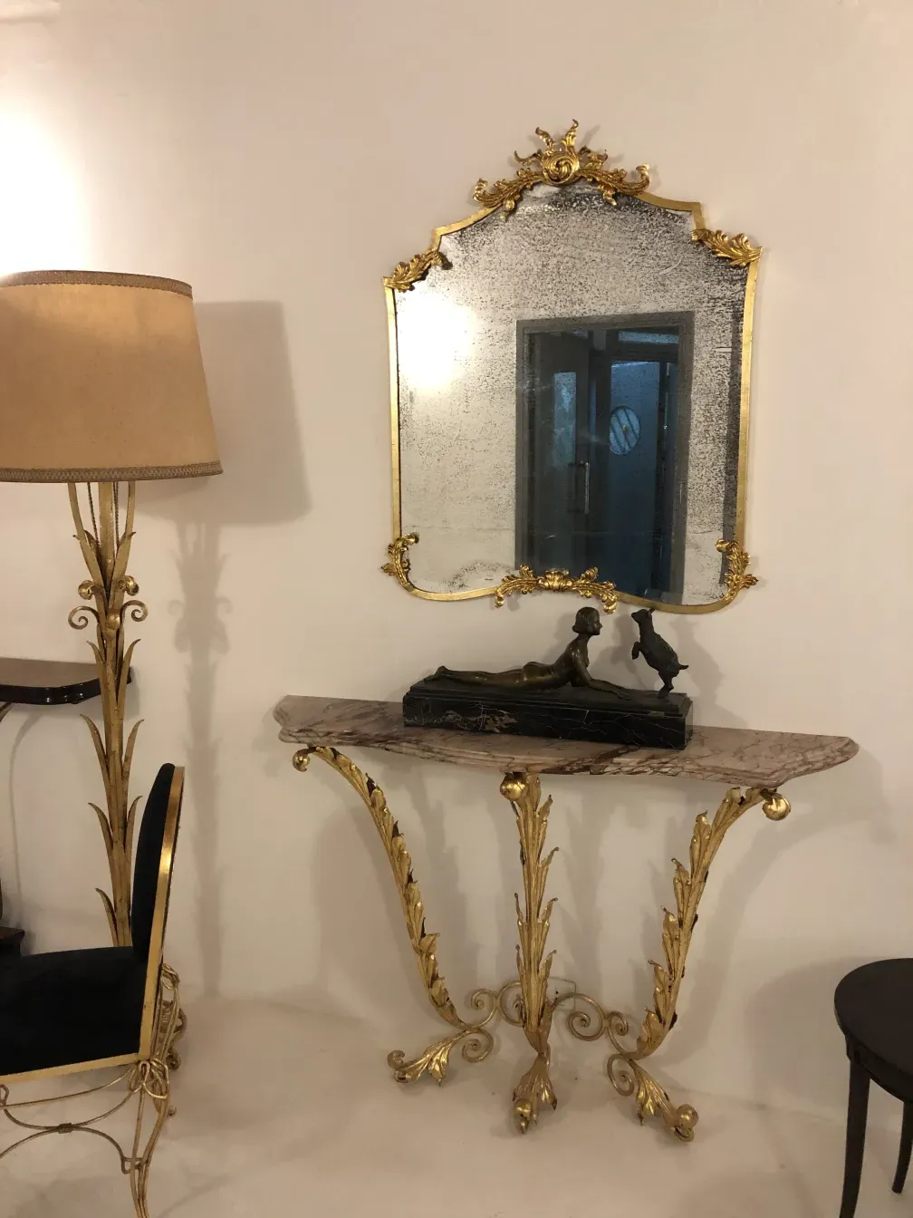 antique console with golden details and mirror