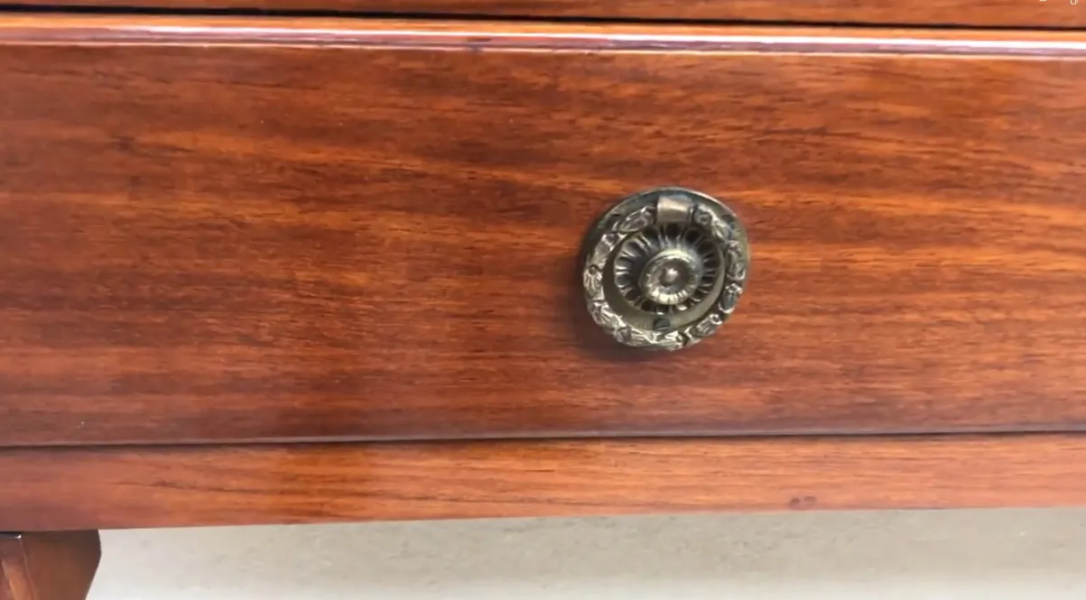 antique console comte with a polished finish and decorative handle details