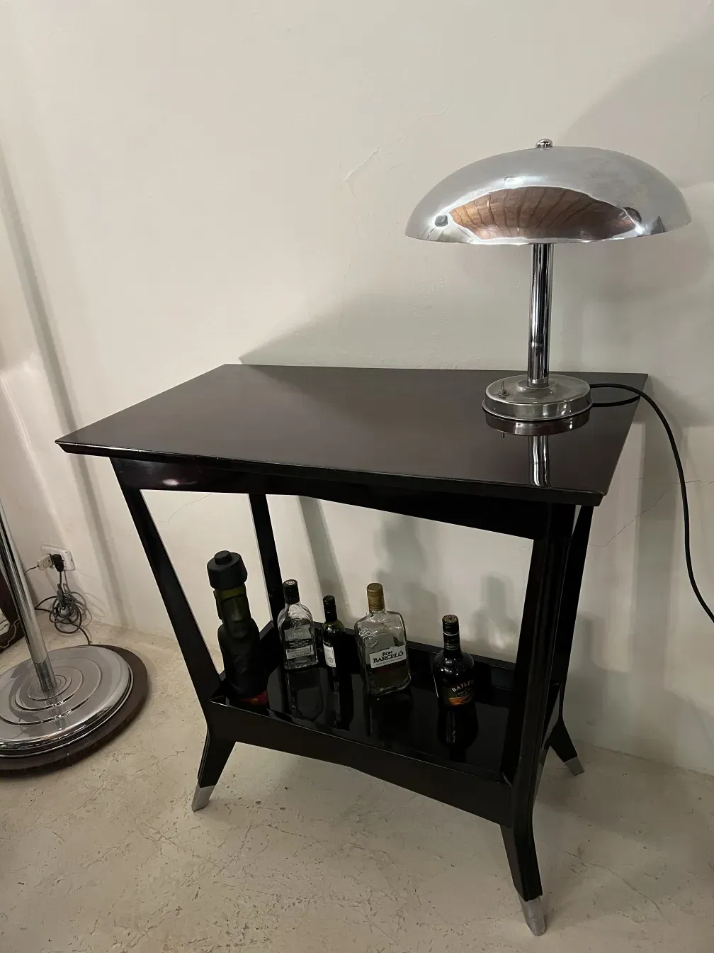 antique bar console with bottles and lamp