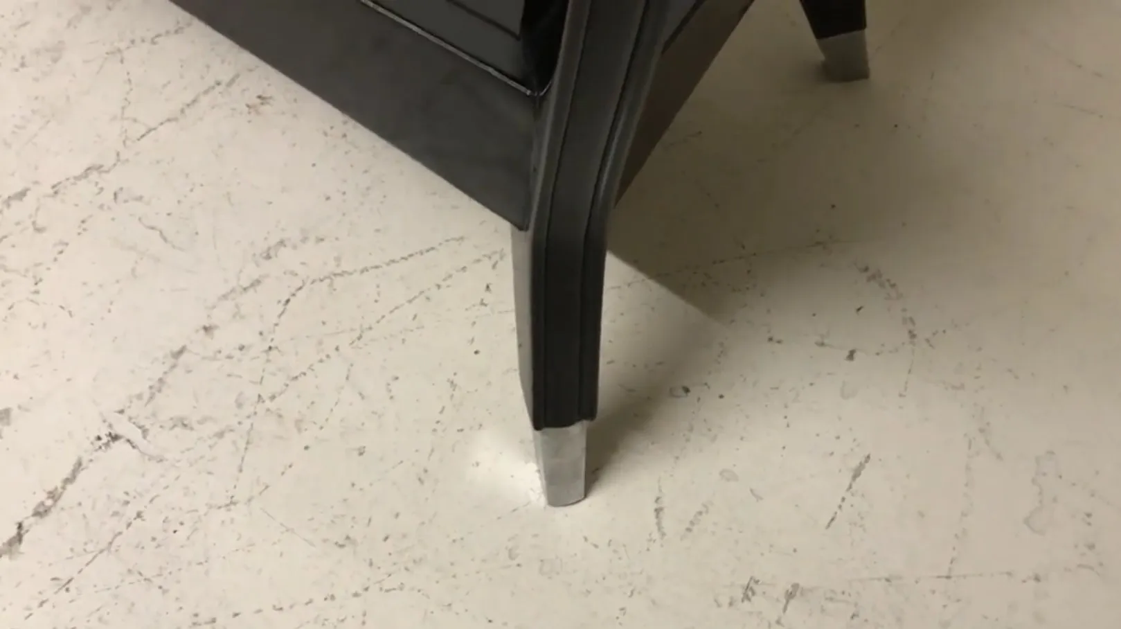 View of the leg of an antique console in a striking environment