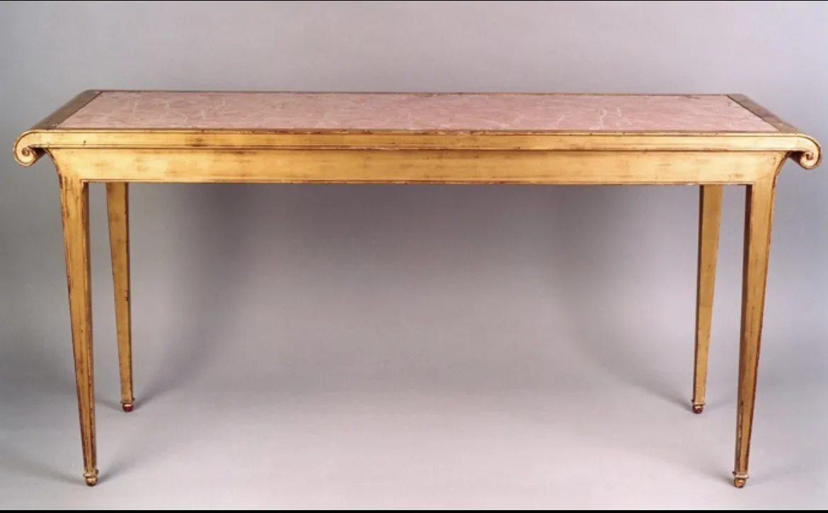 antique console with pink surface and thin legs