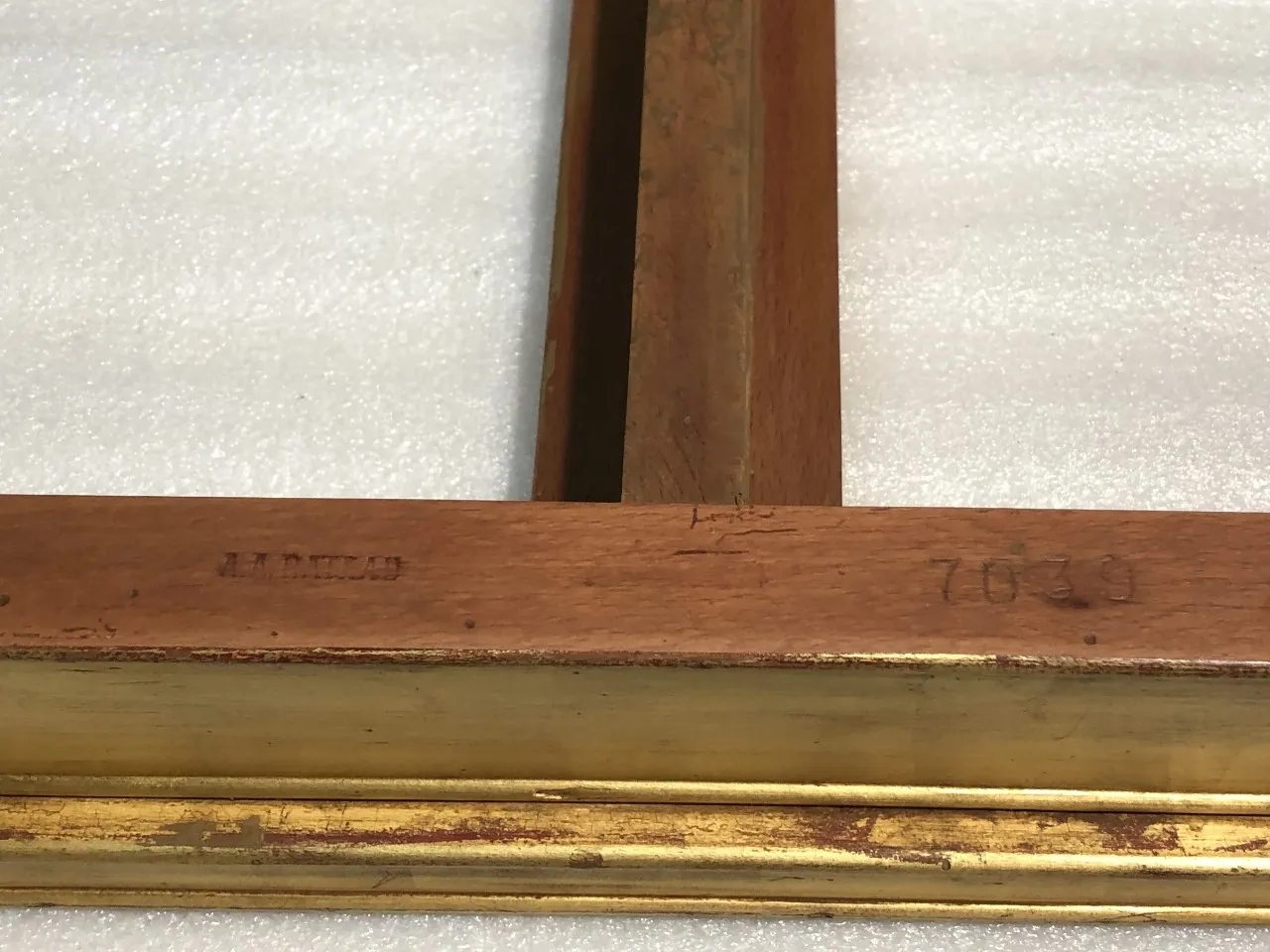 details of an antique console with a golden frame