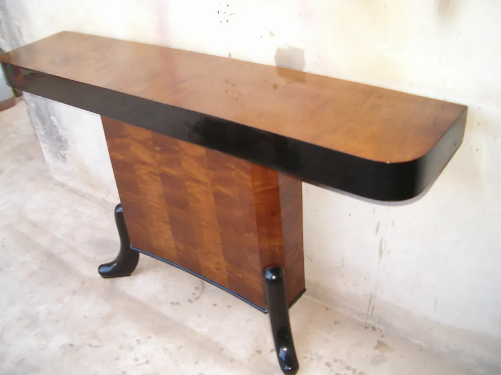 two antique consoles with elegant details in a room