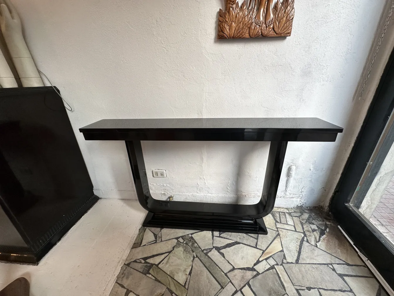 two black antique consoles with an elegant design in a modern setting