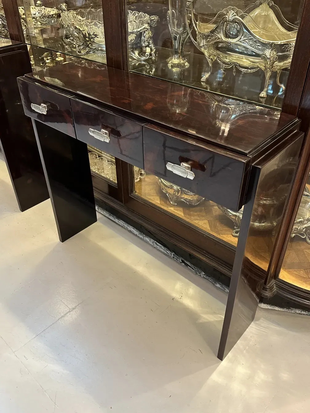 2 antique consoles with decorative drawers in an elegant setting
