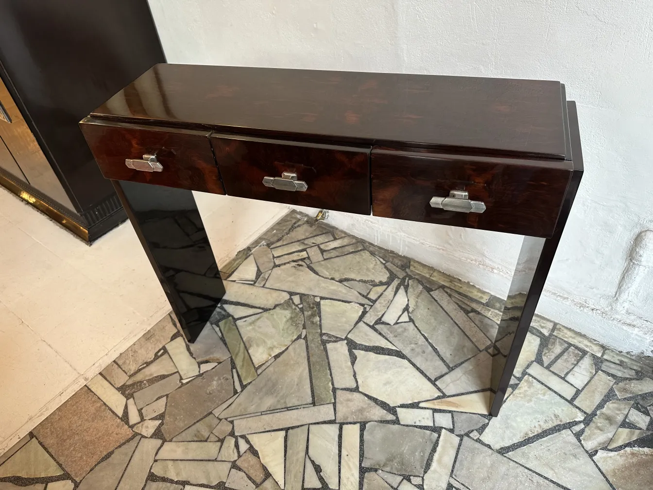 Two antique consoles with drawer details, light background