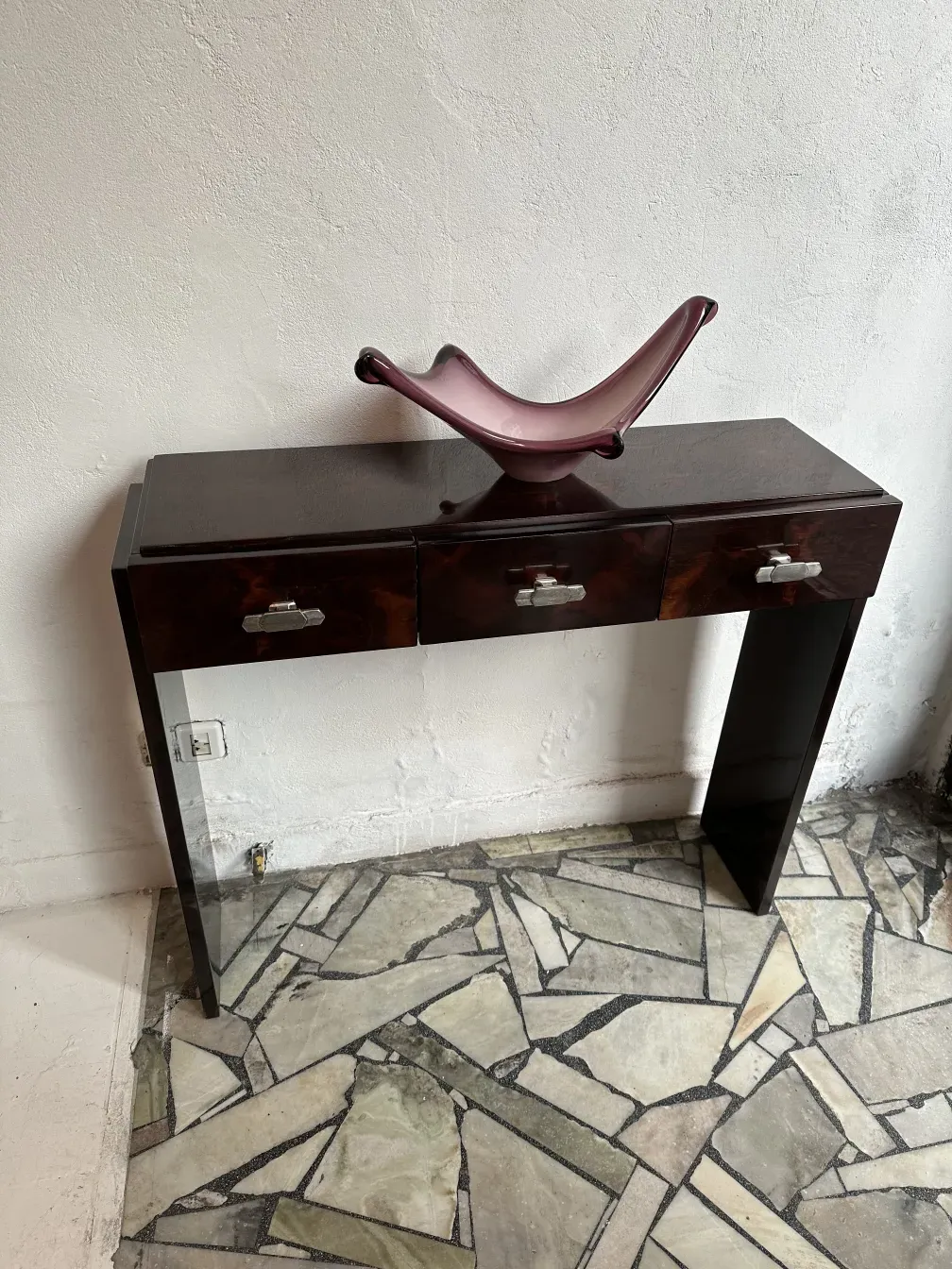 Two antique consoles with a refined design, in an elegant setting.