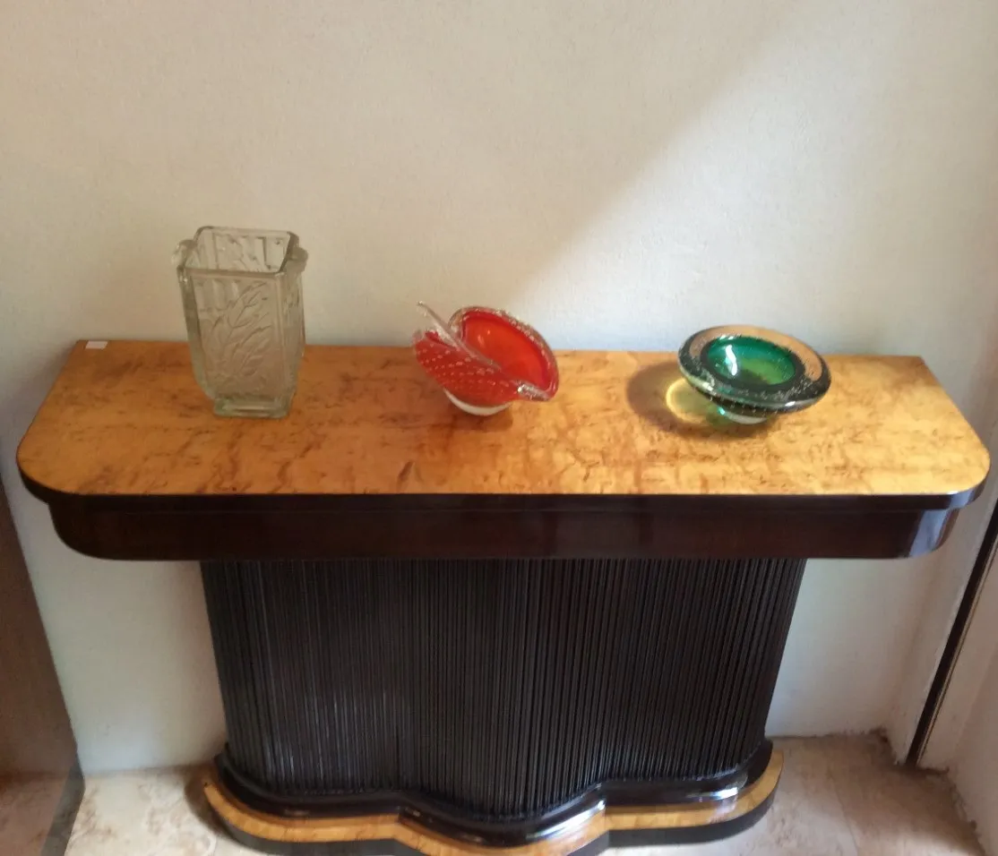 two antique consoles with colorful decorations on top