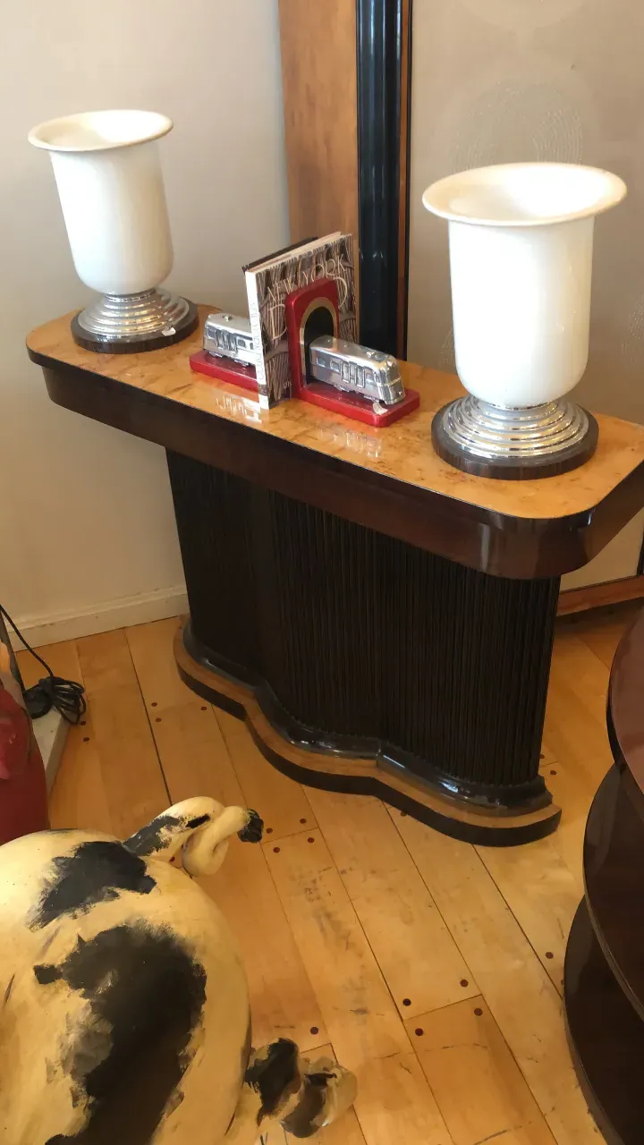 two antique consoles with decorative white lamps