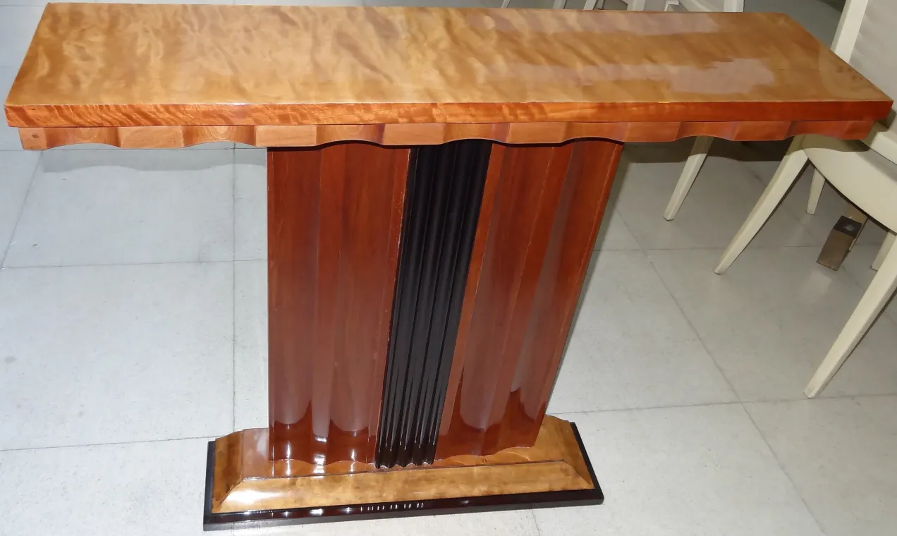 Front view of two antique decorative consoles with an elegant design in a classic setting.