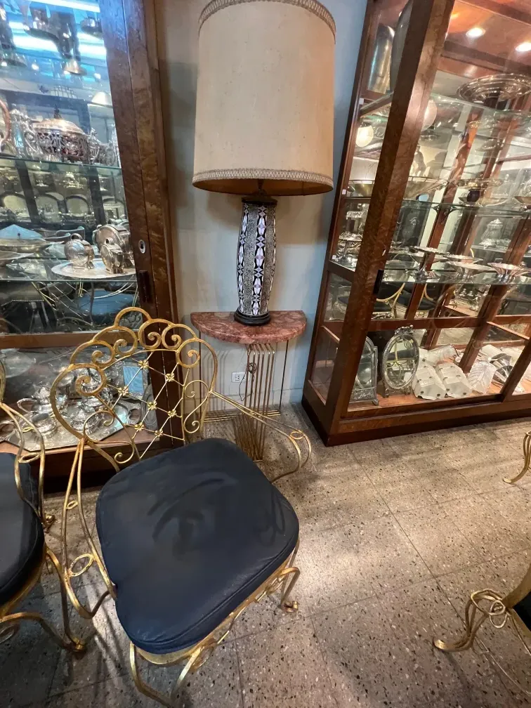 two antique consoles with decorative details in a setting.