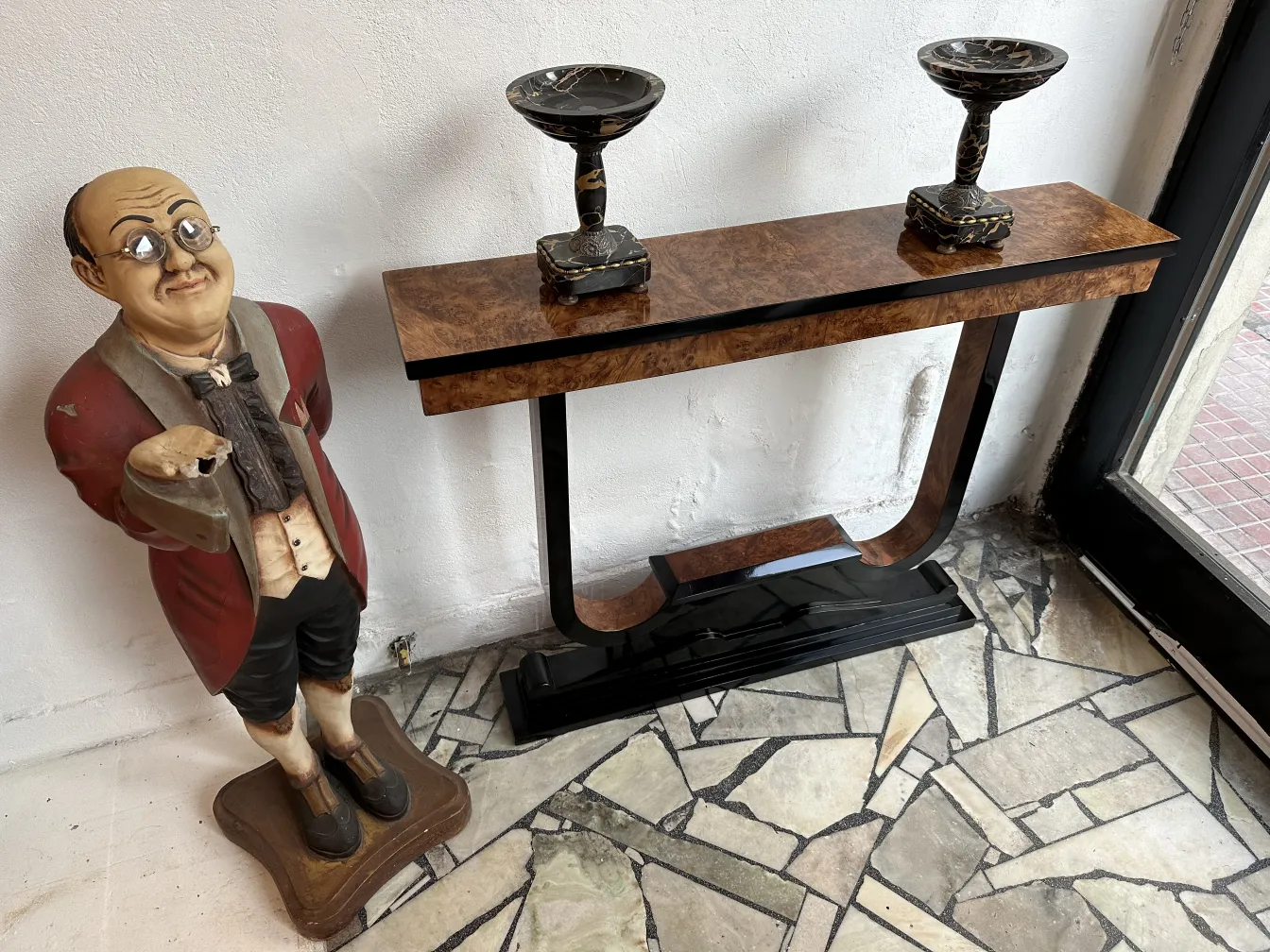 three antique consoles decorated with vases on them