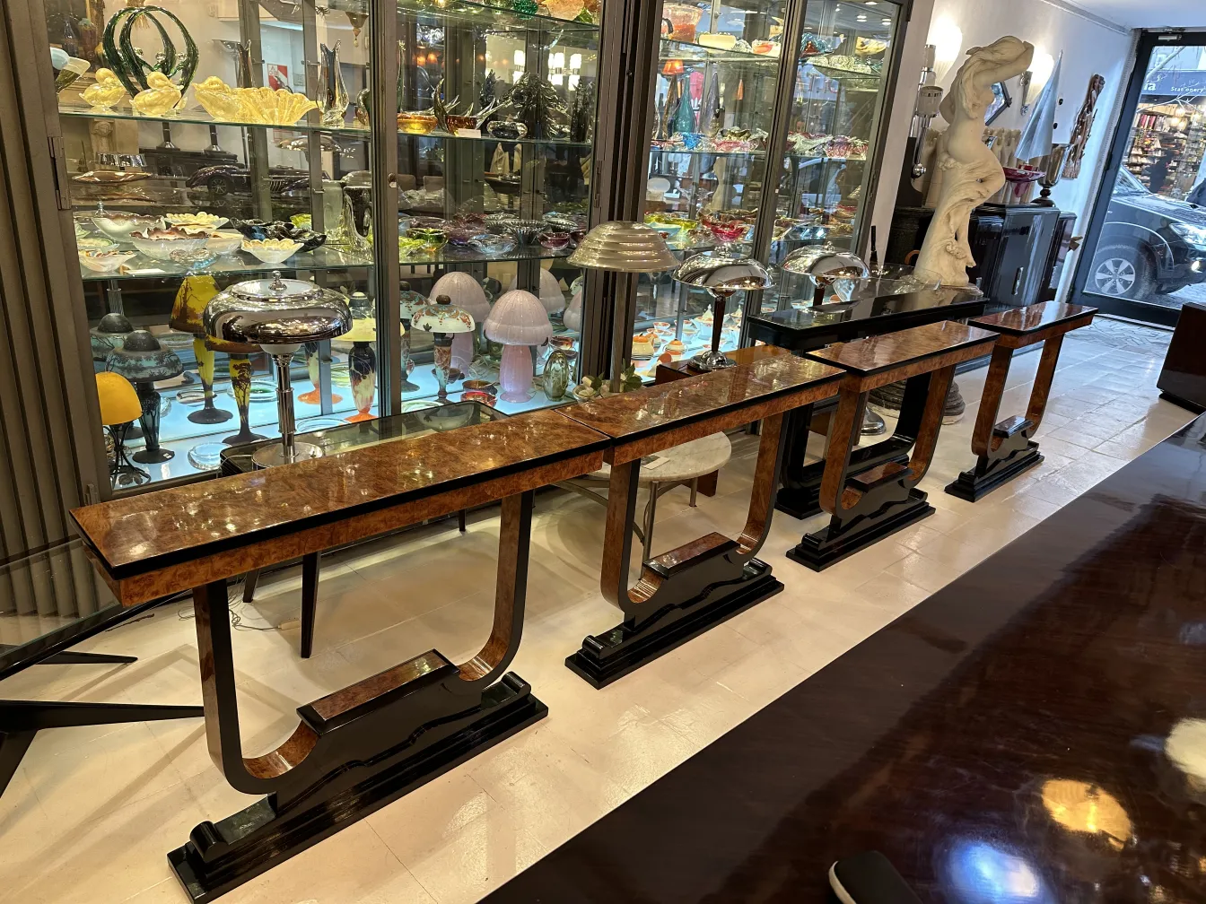 Detail of three antique consoles in a decorative environment with various objects.