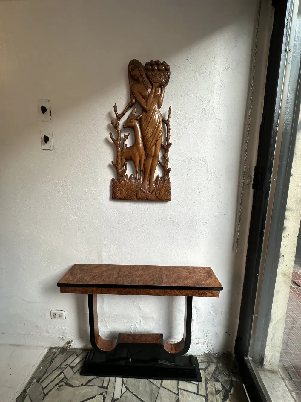 Three antique consoles with unique style against a light wall