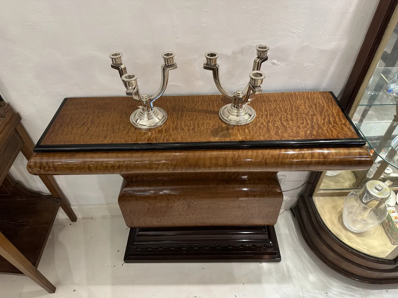 Antique candelabra on a table, featuring a stylish base and three arms