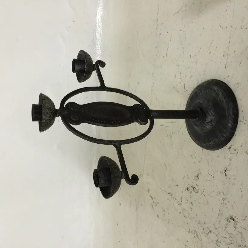 Antique three-armed candelabra with a circular base, classic style