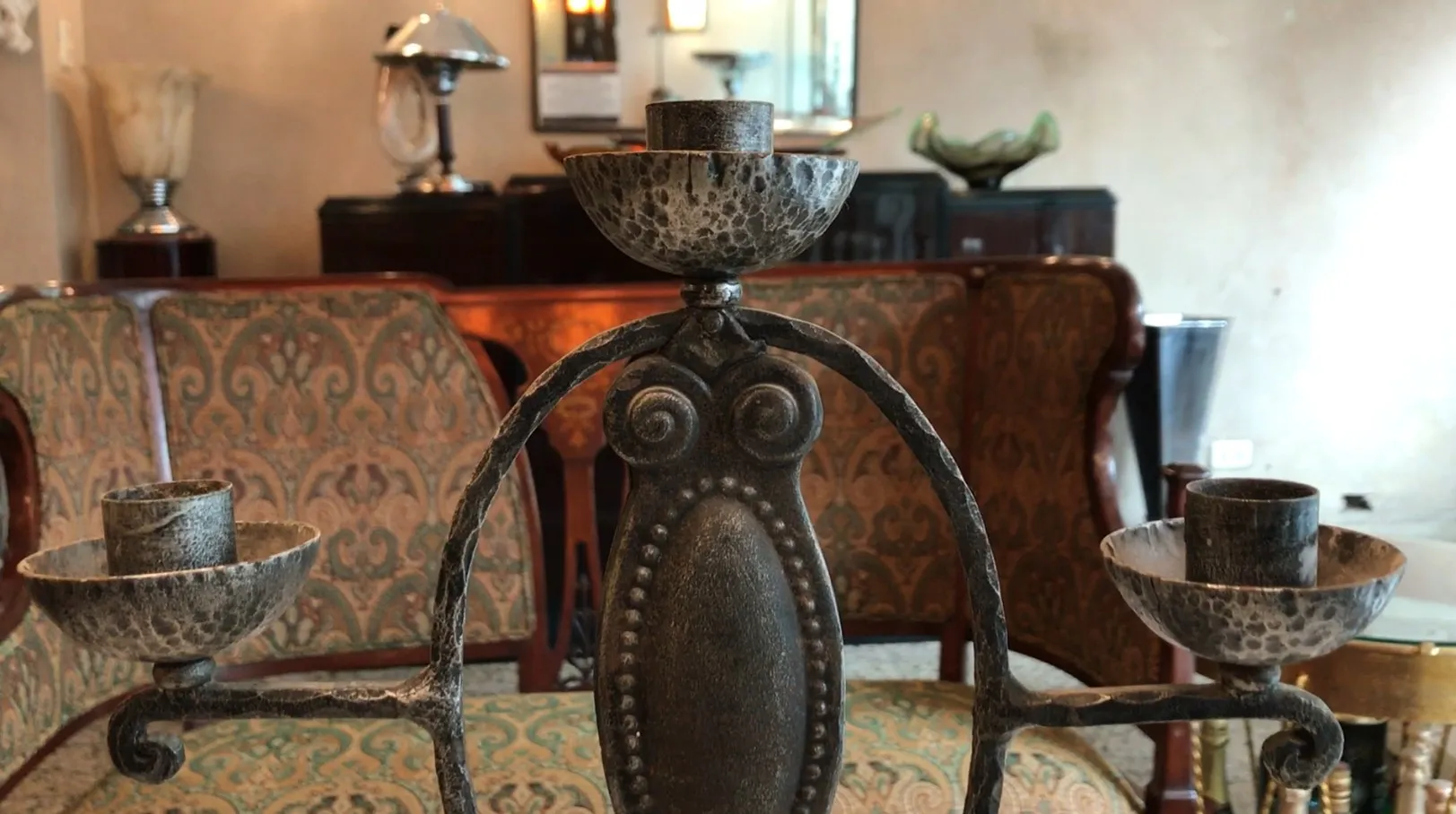 Antique candelabra with intricate design in an elegant setting