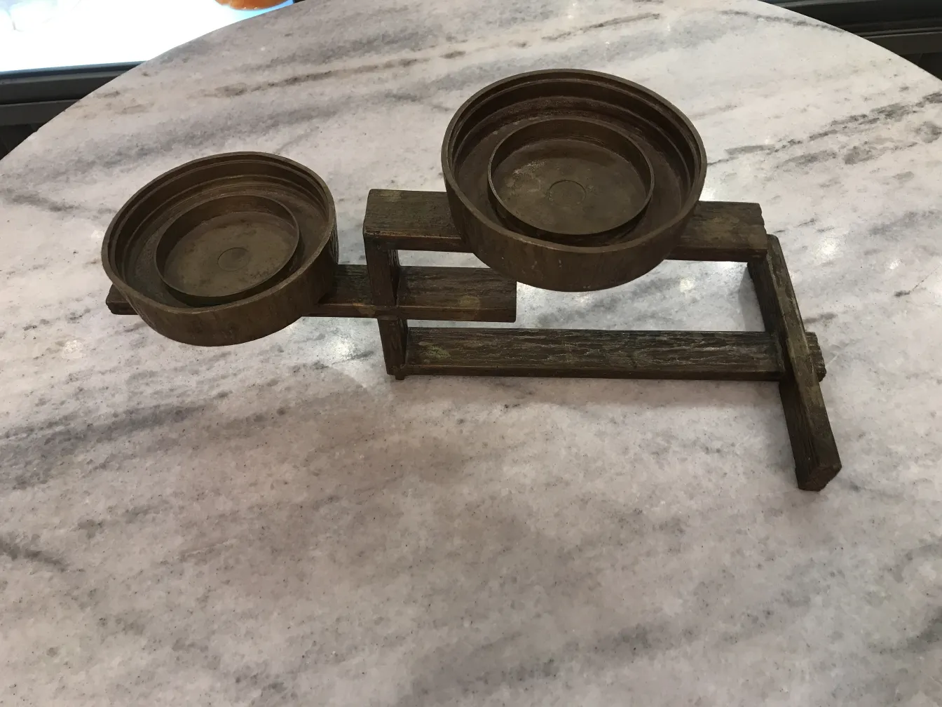 antique candelabra with two round bowls on a stand