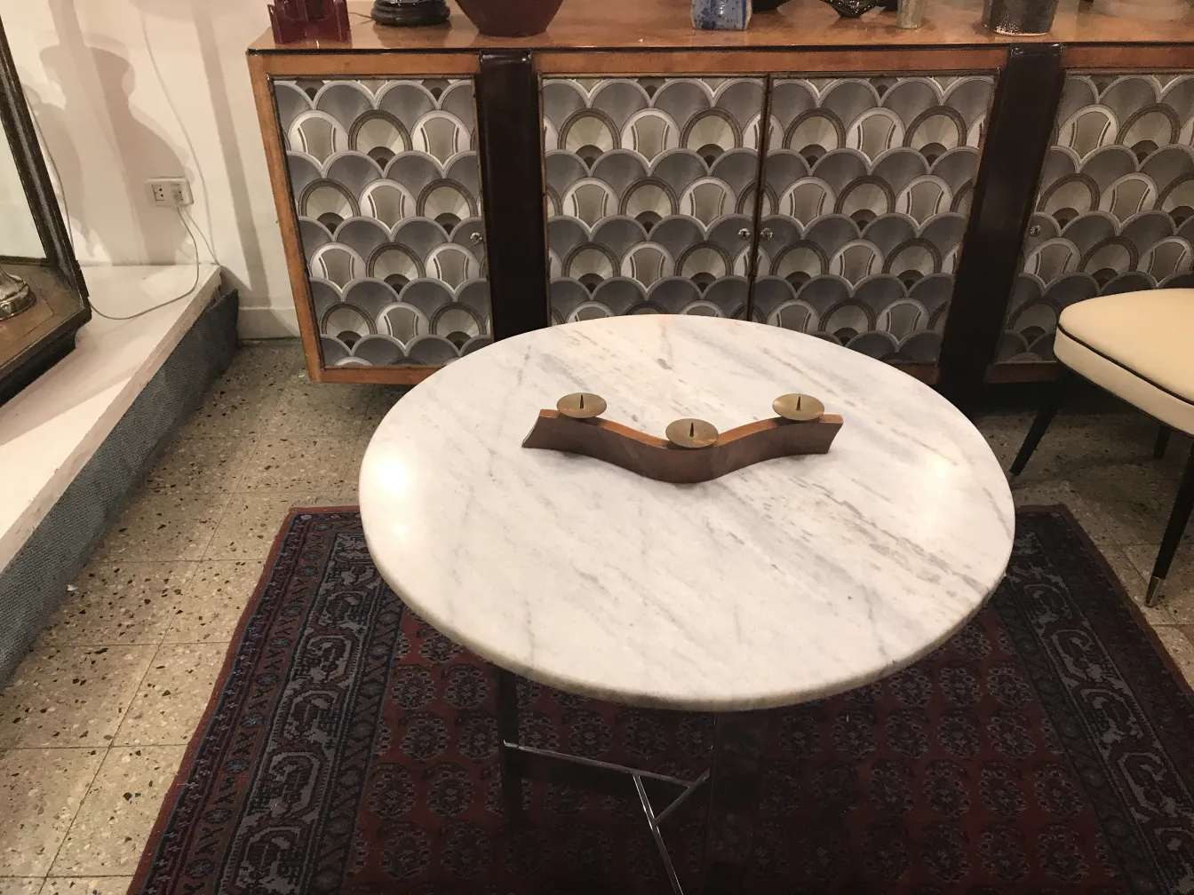 Antique candelabra on marble table with candles