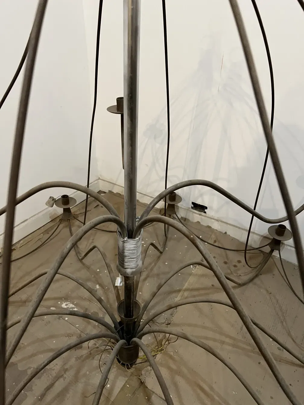 Three antique hanging lamps with elegant cables in a simple setting