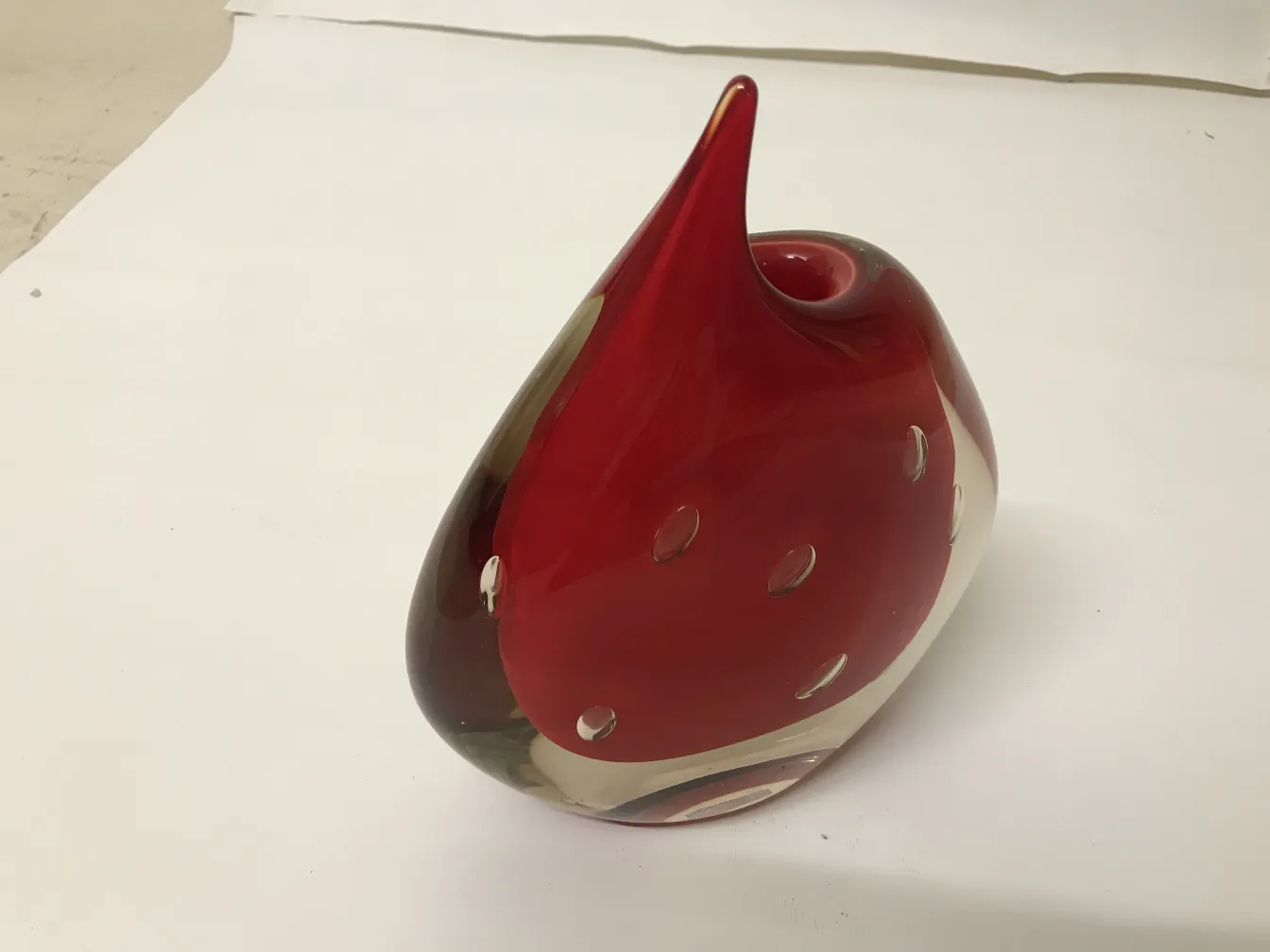 murano vase in red tones with stylized design and decorative holes