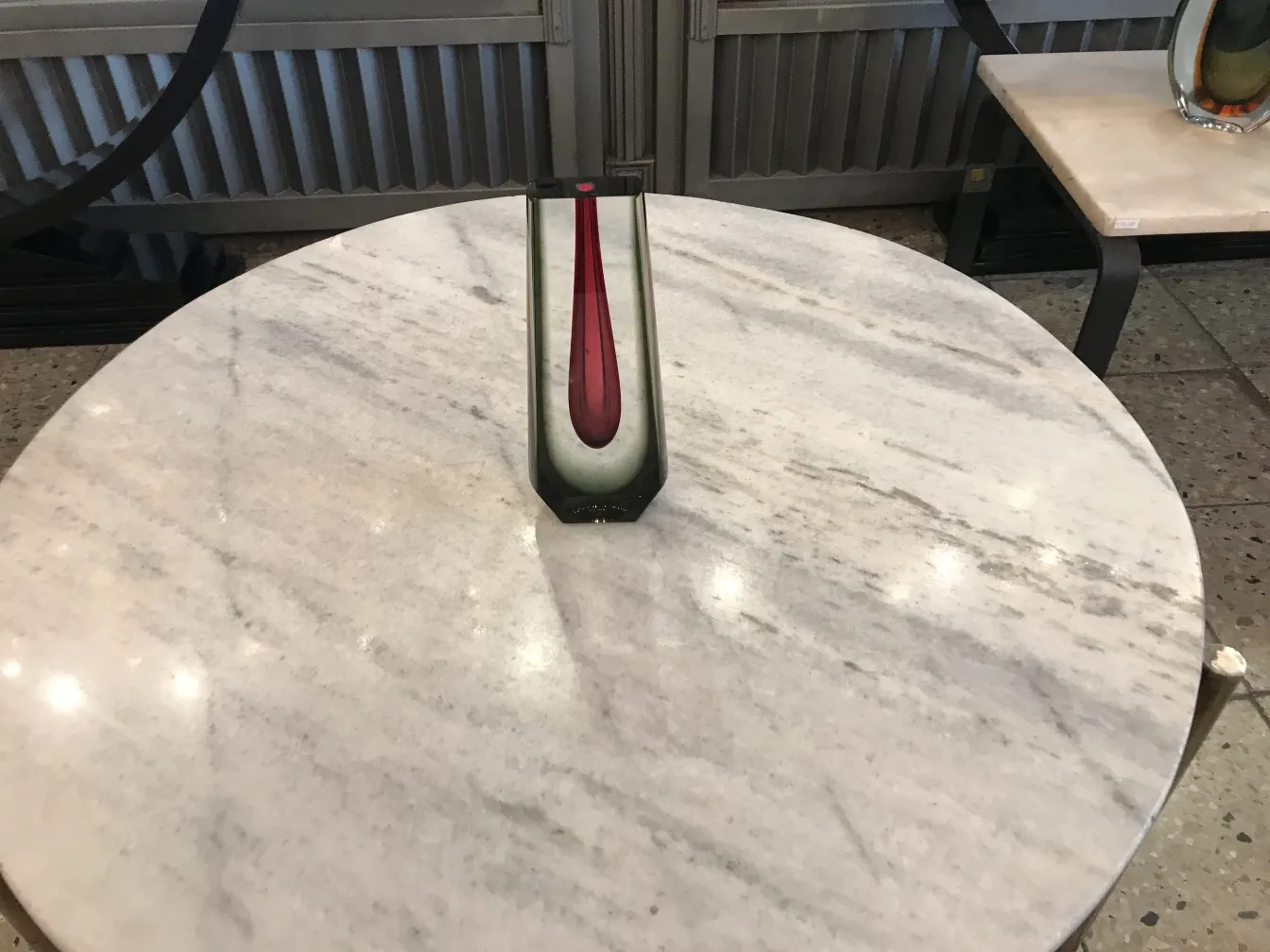 murano vase on a marble table with varied background